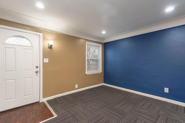 entryway with dark colored carpet