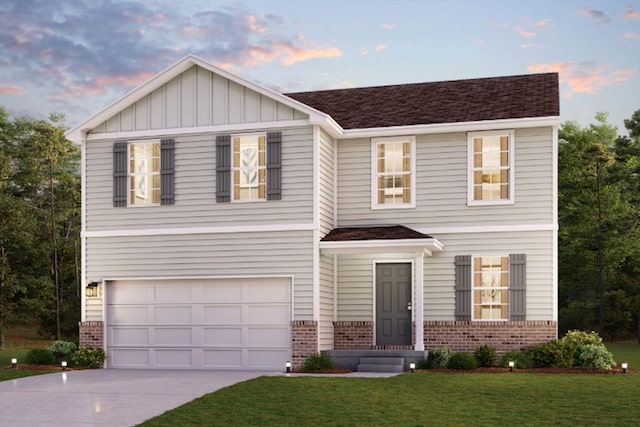 view of front of home with a yard and a garage