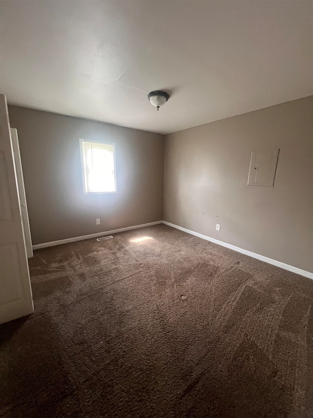 empty room with dark colored carpet