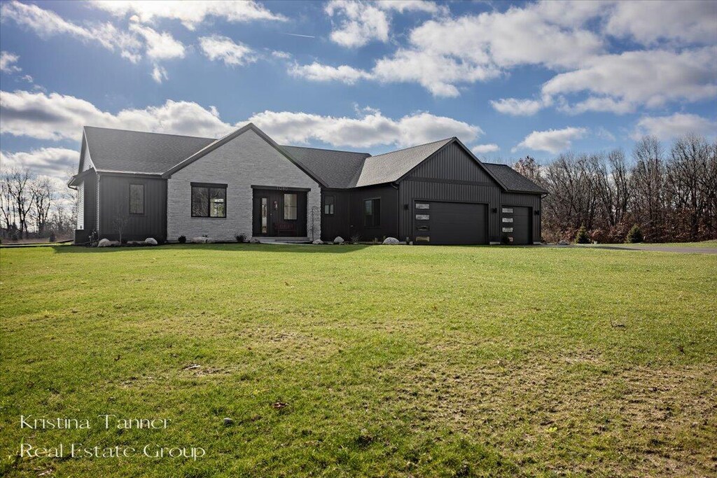 view of front of property with a garage and a front yard