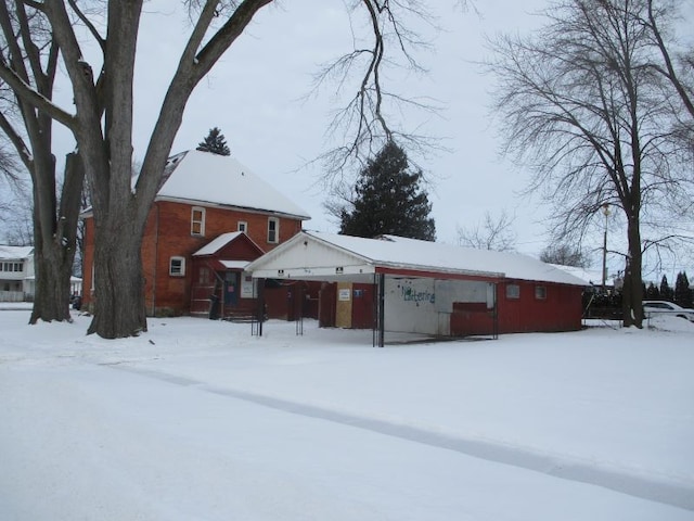 view of snow covered back of property