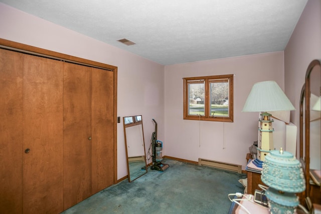 miscellaneous room featuring carpet flooring, a textured ceiling, and a baseboard heating unit