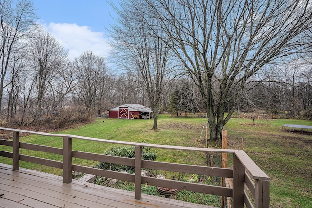 wooden terrace with an outbuilding, a yard, and a barn