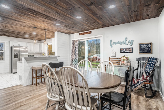 dining space with light wood-type flooring, wood ceiling, and recessed lighting