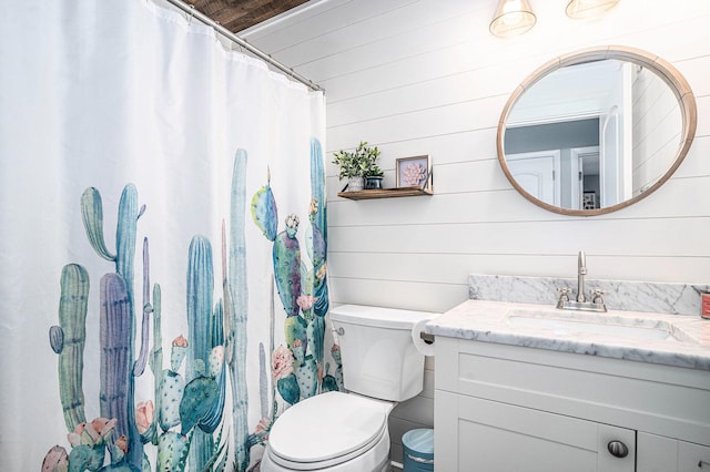 full bathroom featuring a shower with shower curtain, vanity, toilet, and wooden walls