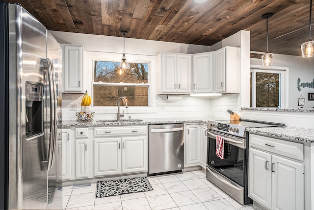 kitchen with marble finish floor, appliances with stainless steel finishes, a sink, and white cabinetry