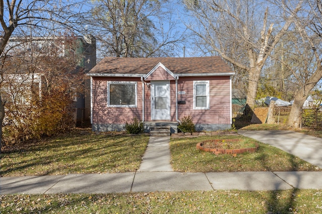 bungalow-style home with a front lawn