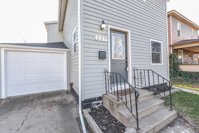 doorway to property with a garage