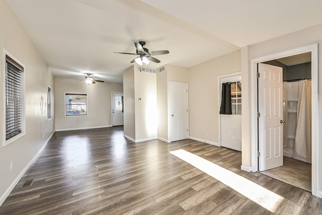 interior space with ceiling fan and dark hardwood / wood-style floors