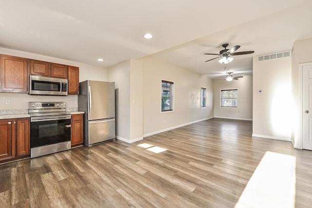 kitchen with ceiling fan, light hardwood / wood-style floors, and stainless steel appliances