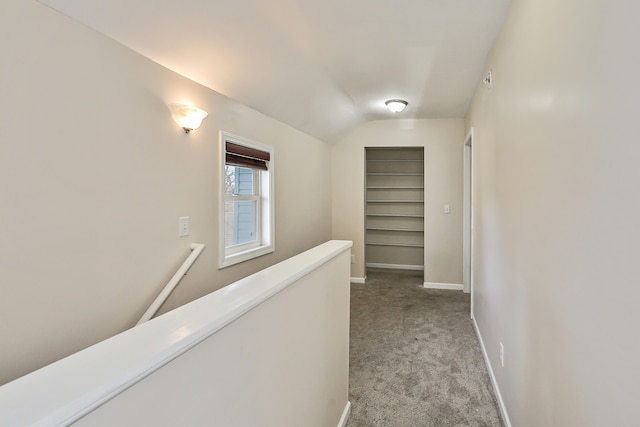 hall featuring light carpet and lofted ceiling