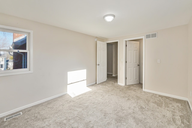 unfurnished bedroom with light carpet