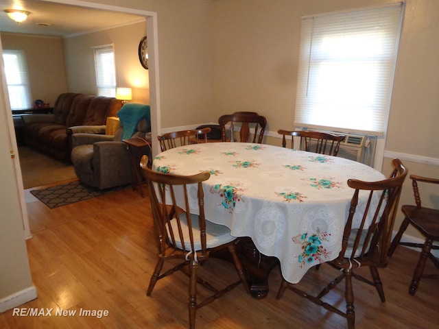 dining room featuring crown molding and light wood-type flooring