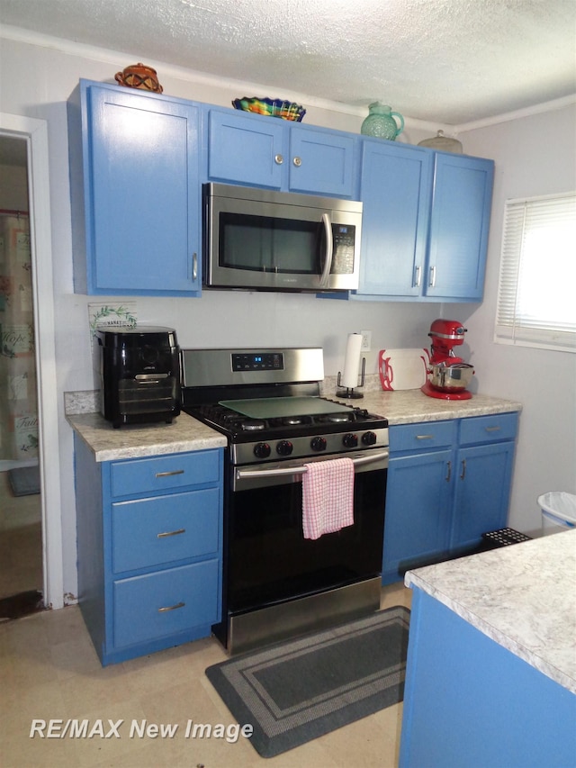 kitchen with appliances with stainless steel finishes and blue cabinets