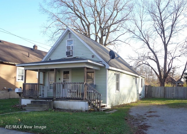 bungalow with a front lawn and a porch