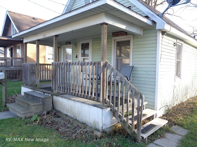 view of exterior entry featuring a porch