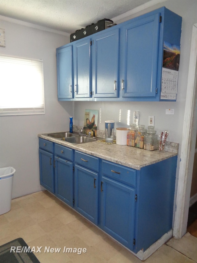 kitchen with blue cabinets and a textured ceiling