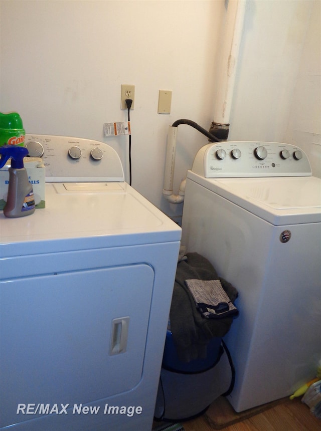 laundry area featuring independent washer and dryer and dark wood-type flooring