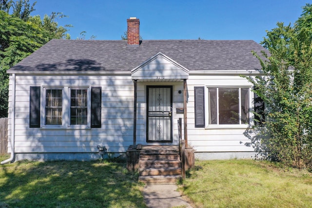 bungalow-style home with a front yard