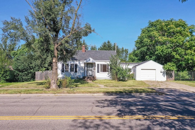 single story home with a front yard and a garage