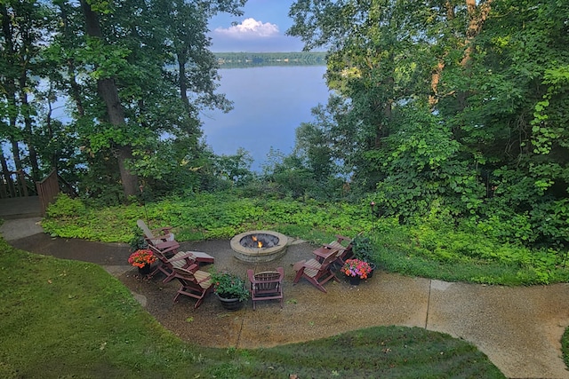 view of yard featuring a water view and an outdoor fire pit