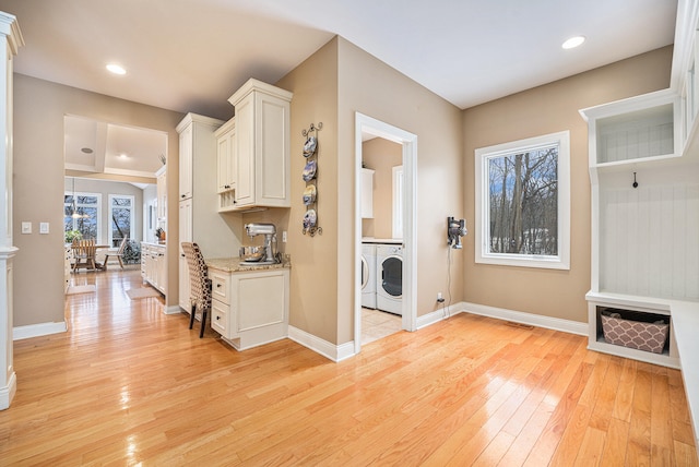 washroom with light wood-style flooring, washer and dryer, recessed lighting, cabinet space, and baseboards