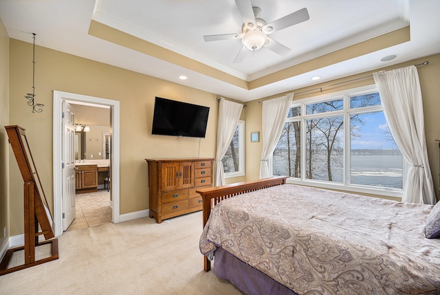 bedroom featuring a tray ceiling, ornamental molding, and light carpet