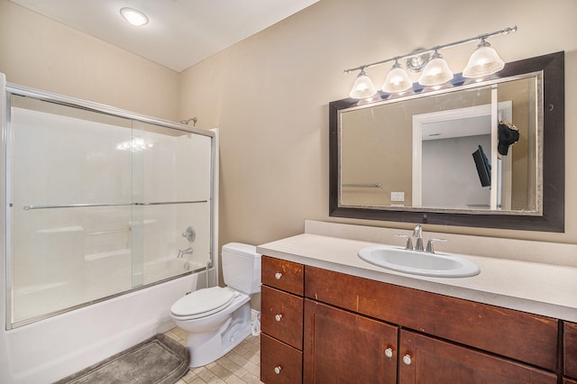 full bath with combined bath / shower with glass door, toilet, vanity, and tile patterned flooring