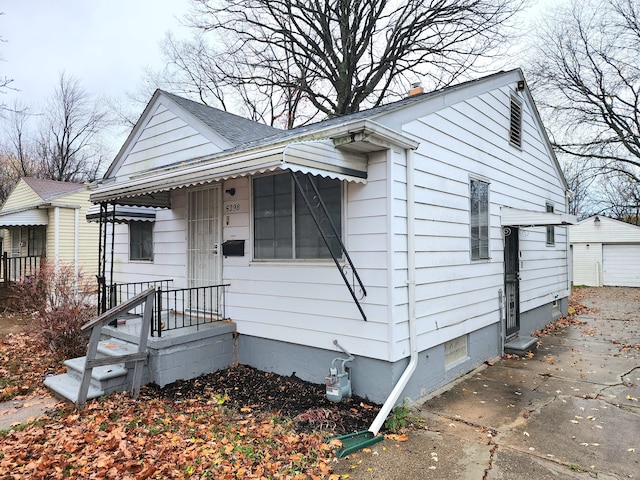 5298 Neff Ave, Detroit, MI 48224 - view of front of house with a detached garage and an outdoor structure