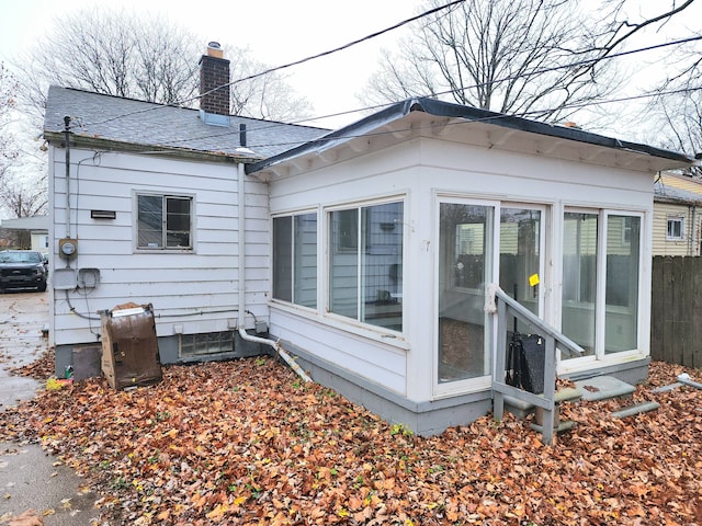 5298 Neff Ave, Detroit, MI 48224 - back of property featuring a chimney, a sunroom, and a shingled roof