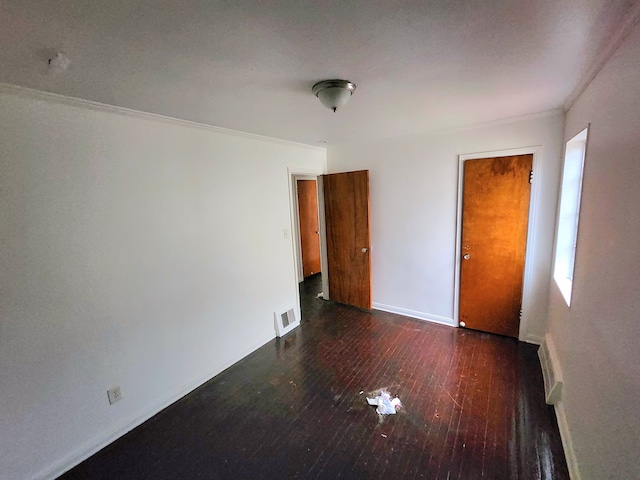 unfurnished room featuring dark hardwood / wood-style floors and ornamental molding