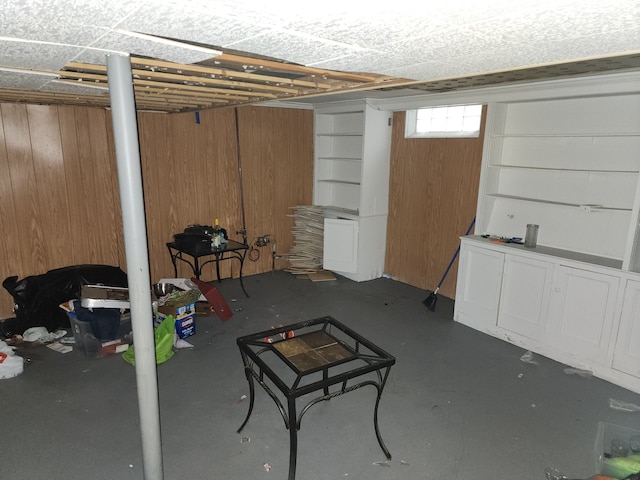 basement featuring wood walls