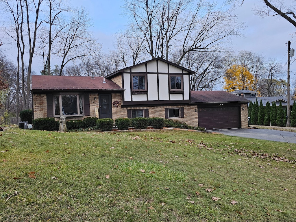 view of front of property featuring a garage and a front lawn