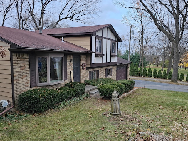 view of front of house with a front yard and a garage