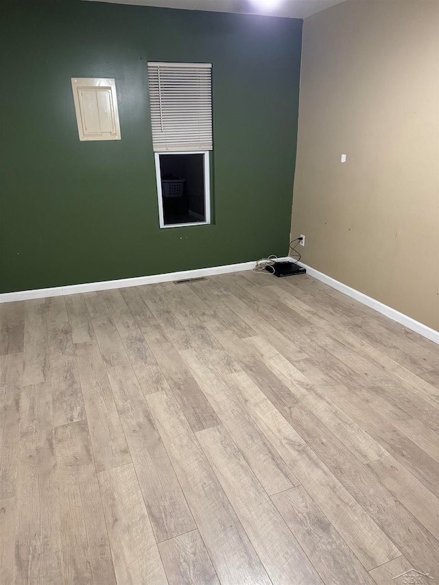 unfurnished room with light hardwood / wood-style flooring