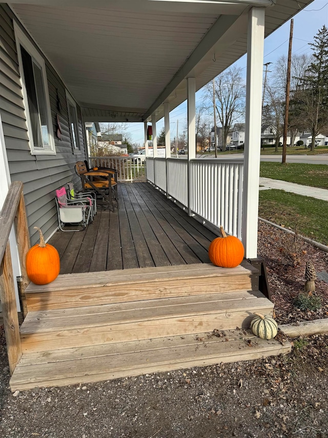 wooden terrace featuring covered porch