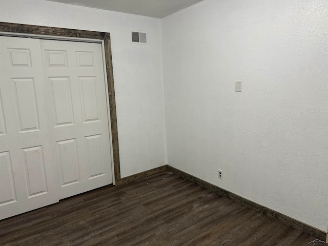 interior space with dark hardwood / wood-style floors and a closet