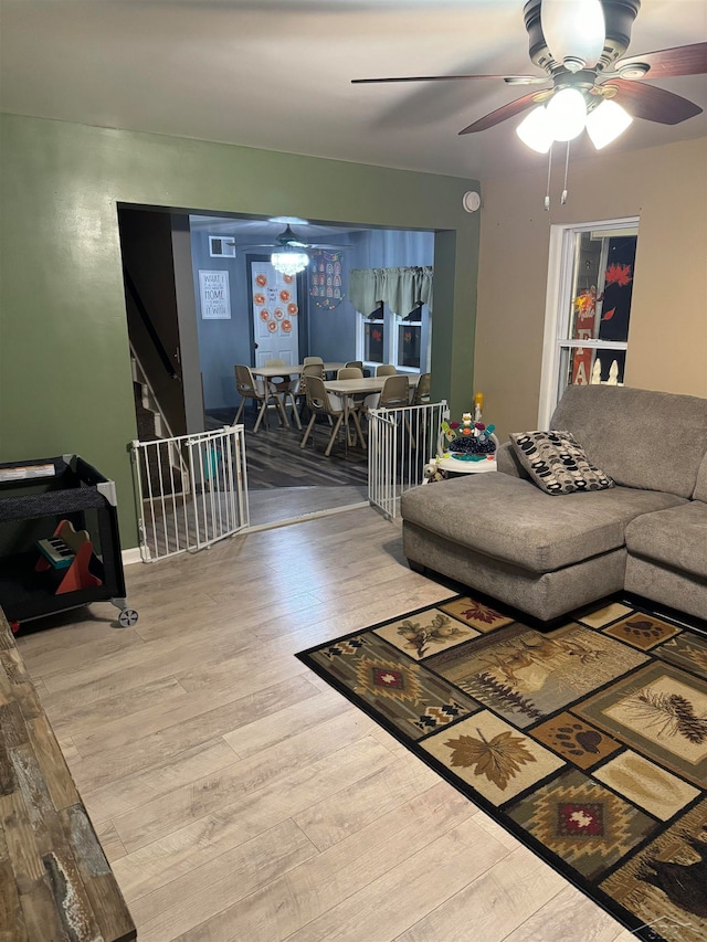 living room with ceiling fan and hardwood / wood-style flooring