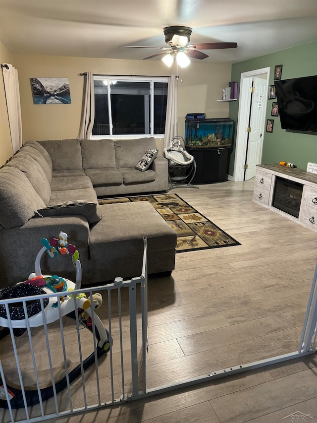 living room with hardwood / wood-style floors and ceiling fan