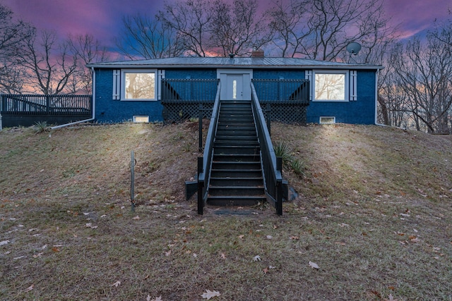 3897 Sand Rd, Port Austin, MI 48467 - view of front of house featuring stairway, a deck, metal roof, and crawl space