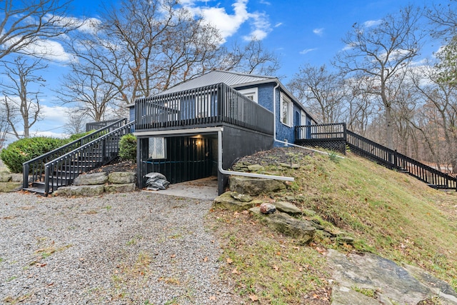 3897 Sand Rd, Port Austin, MI 48467 - view of property exterior featuring stairs and a wooden deck