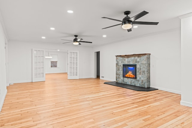 3897 Sand Rd, Port Austin, MI 48467 - unfurnished living room with light wood-style flooring, ceiling fan, baseboards, recessed lighting, and crown molding