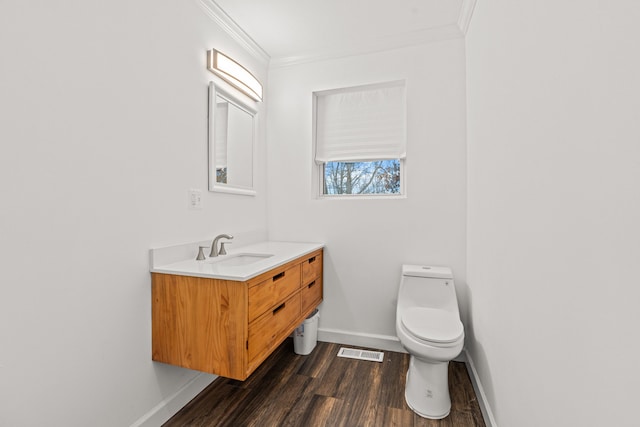 3897 Sand Rd, Port Austin, MI 48467 - bathroom with crown molding, vanity, wood finished floors, baseboards, and toilet