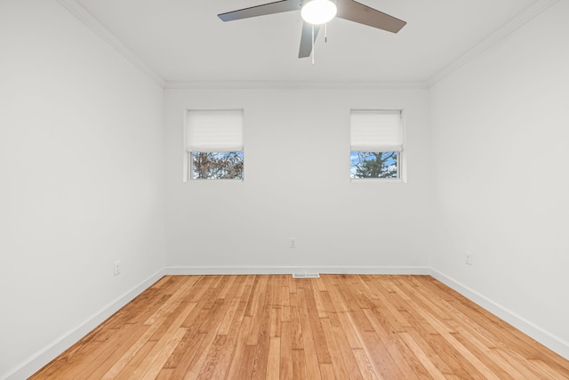 3897 Sand Rd, Port Austin, MI 48467 - spare room featuring ornamental molding, plenty of natural light, baseboards, light wood-type flooring, and a ceiling fan