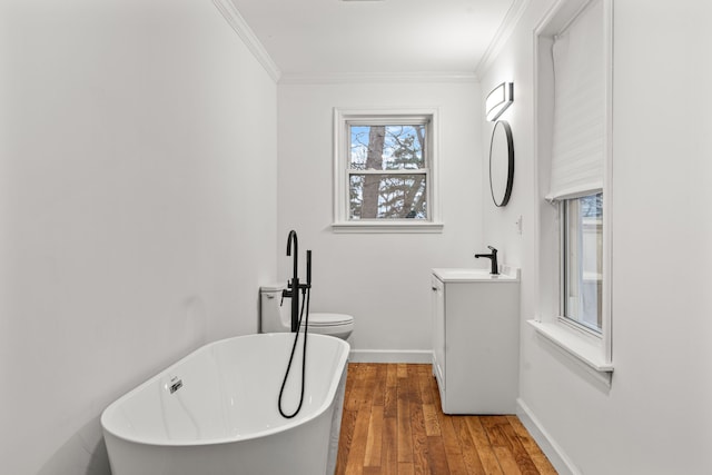 3897 Sand Rd, Port Austin, MI 48467 - bathroom featuring vanity, a soaking tub, healthy amount of natural light, wood finished floors, and crown molding