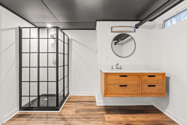 3897 Sand Rd, Port Austin, MI 48467 - bathroom featuring a stall shower, vanity, wood finished floors, and baseboards