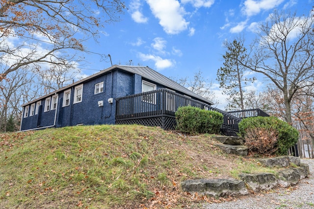 3897 Sand Rd, Port Austin, MI 48467 - view of home's exterior featuring a deck and metal roof