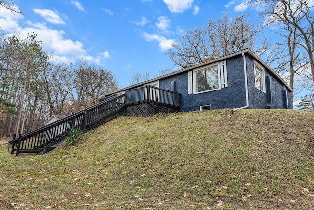 3897 Sand Rd, Port Austin, MI 48467 - rear view of property featuring stairway, a deck, a lawn, and a chimney