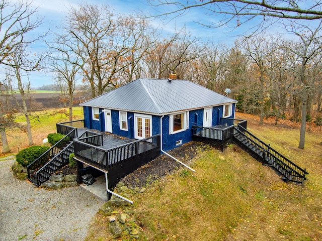 3897 Sand Rd, Port Austin, MI 48467 - back of house featuring a wooden deck, metal roof, stairway, and french doors