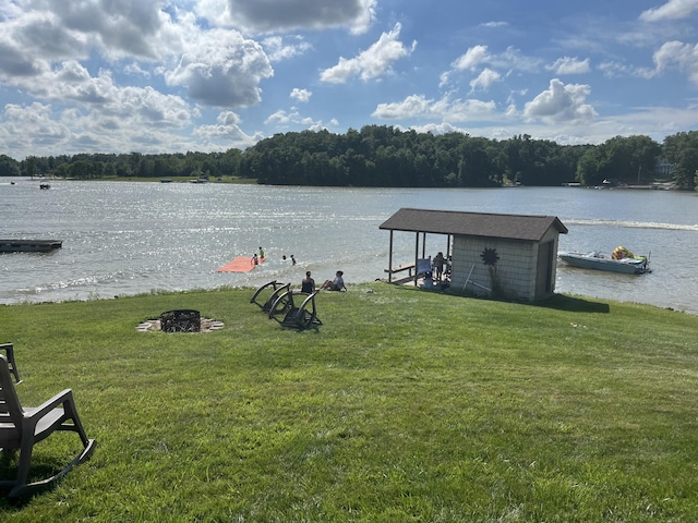14600 W Diane Dr, Camden, MI 49232 - water view with a boat dock, an outdoor fire pit, and a heavily wooded area
